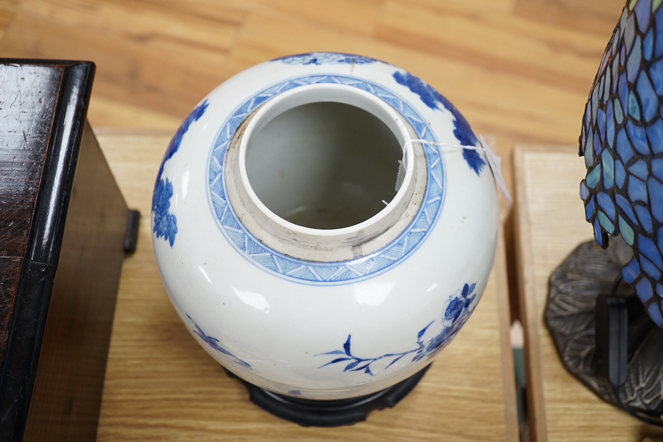 A large Chinese blue and white porcelain jar, 19th century decorated with scenes of birds amongst foliage with associated pierced hardwood cover and stand, 29cms high including stand and cover